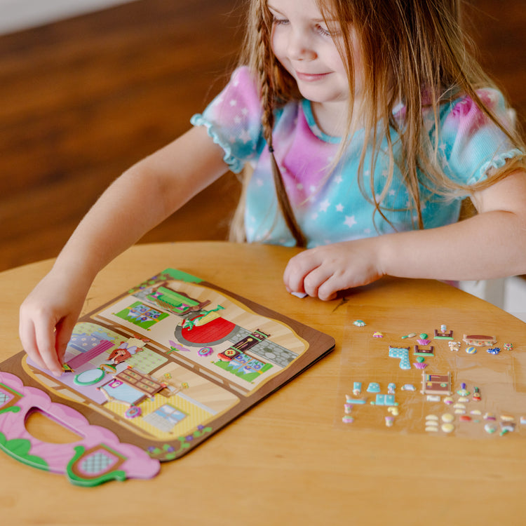 A kid playing with The Melissa & Doug Puffy Sticker Activity Books Set - Farm, Safari, and Chipmunk