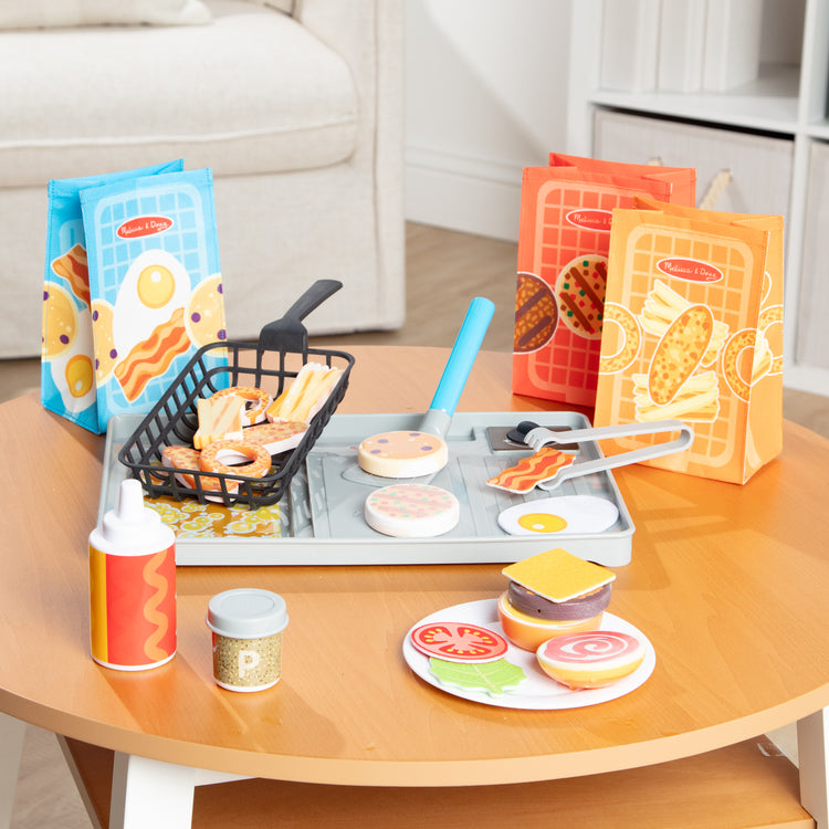 A playroom scene with The Melissa & Doug Flip & Fry Grill Play Set with Water WOW!® Color Reveal Play Food Preschool Toy Ages 3+