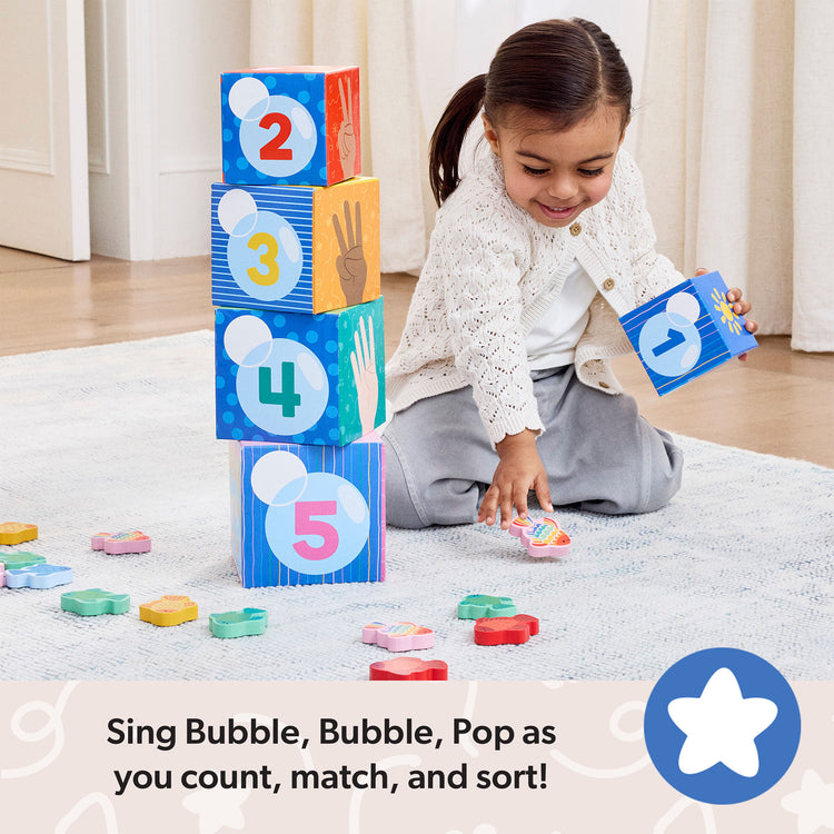 A playroom scene with The Melissa & Doug® Ms. Rachel™ Sort and Count Nesting and Stacking Blocks with Wooden Fish Preschool Learning Toy for Boys, Girls