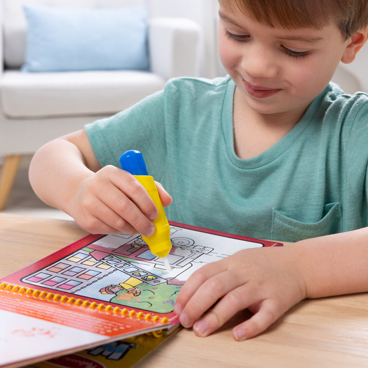 A kid playing with The Water WOW! Bundle 6-Pack: Animals, Vehicles, Alphabet, Numbers, Safari, Under the Sea
