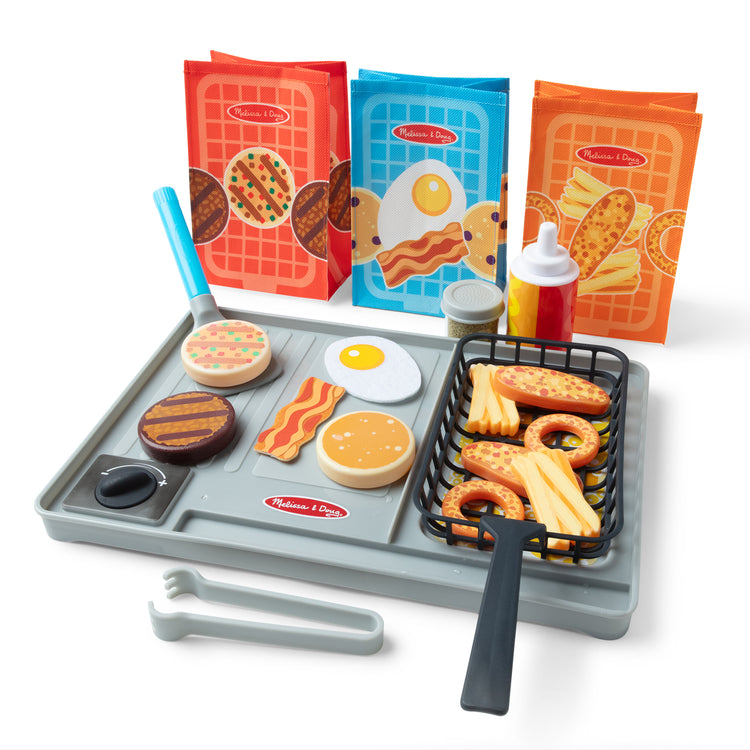 A playroom scene with The Melissa & Doug Flip & Fry Grill Play Set with Water WOW!® Color Reveal Play Food Preschool Toy Ages 3+