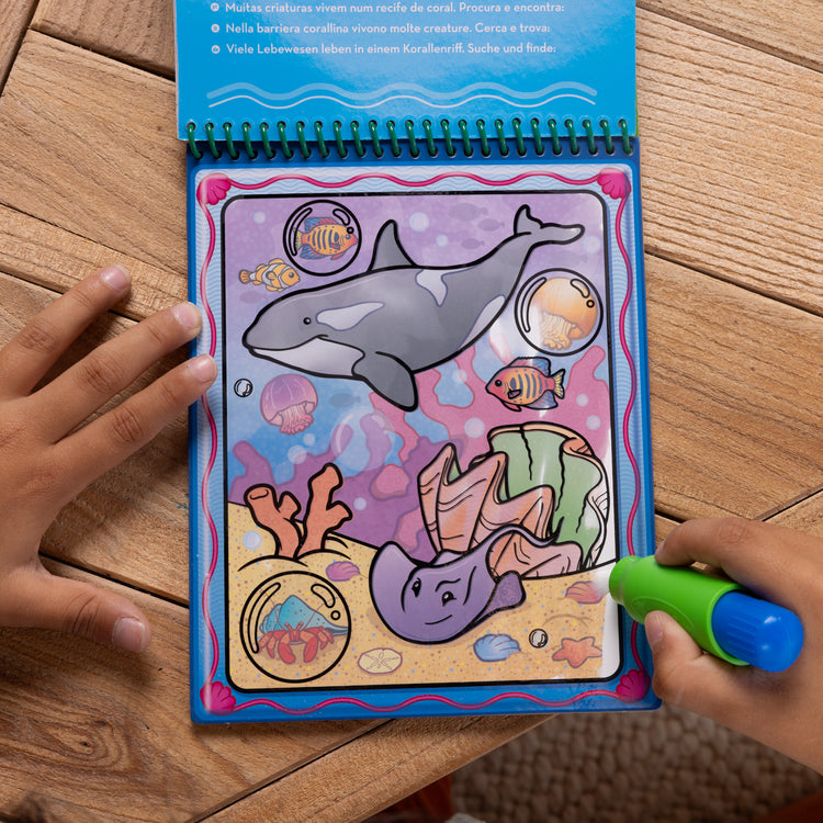 A kid playing with The Water WOW! Bundle 6-Pack: Animals, Vehicles, Alphabet, Numbers, Safari, Under the Sea