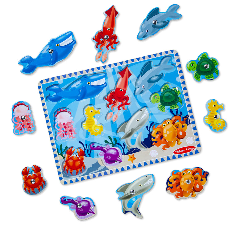 A kid playing with The Melissa & Doug Magnetic Wooden Fishing Game and Puzzle With Wooden Ocean Animal Magnets
