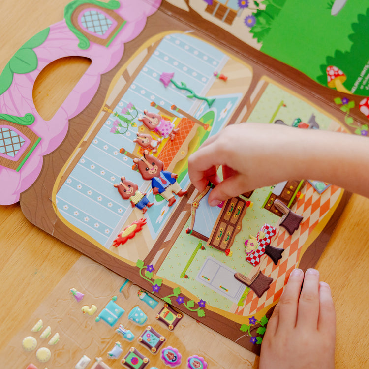 A kid playing with The Melissa & Doug Puffy Sticker Activity Books Set - Farm, Safari, and Chipmunk