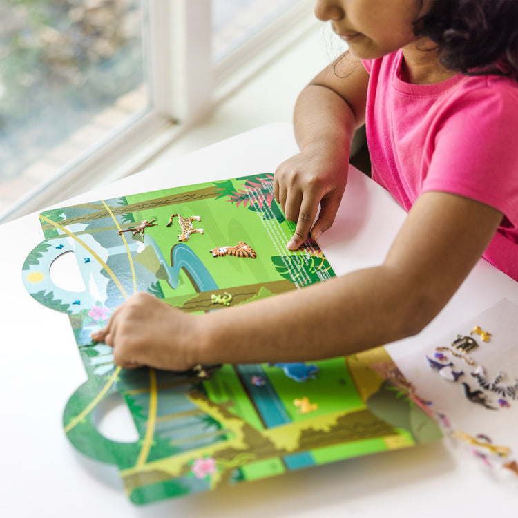 A kid playing with The Melissa & Doug Puffy Sticker Activity Books Set - Farm, Safari, and Chipmunk