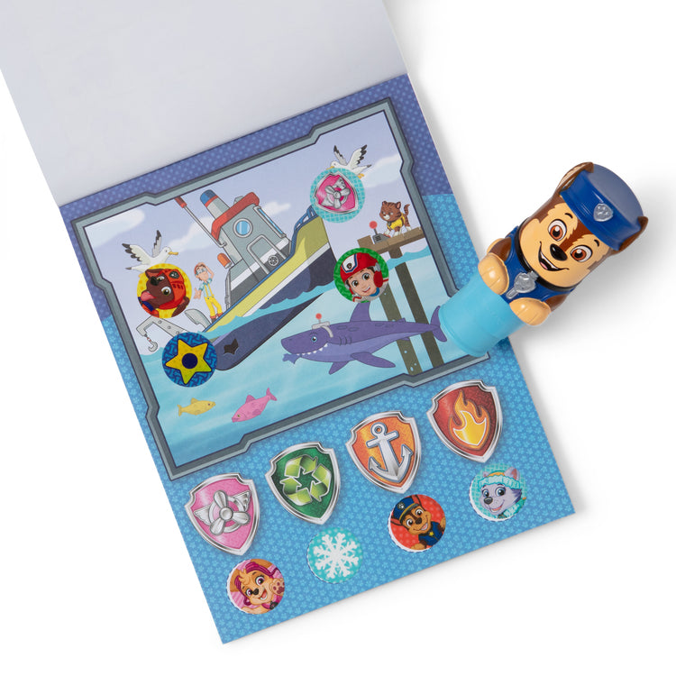 The loose pieces of The Melissa & Doug Sticker WOW!™ 24-Page Activity Pad and Sticker Stamper, 300 Stickers, Arts and Crafts Fidget Toy Collectible Character – PAW Patrol Chase
