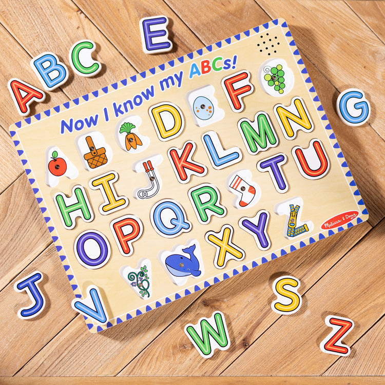 A playroom scene with The Melissa & Doug Wooden Alphabet Sound Puzzle - Wooden Puzzle With Light-Activated Sound Effects (26 pcs)