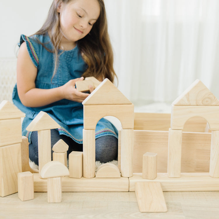 child playing with wooden blocks