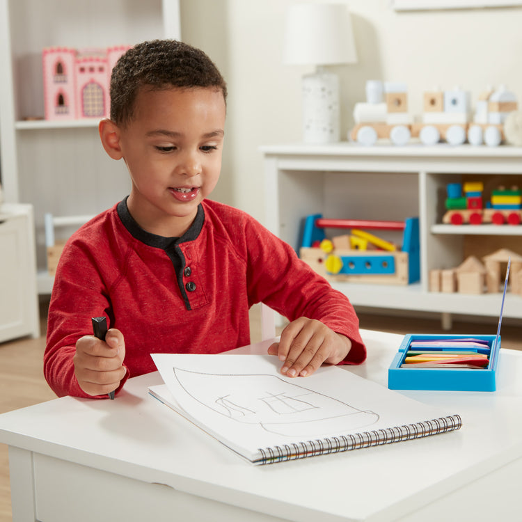 A kid playing with The Sketch Pad (9\\x12\\)