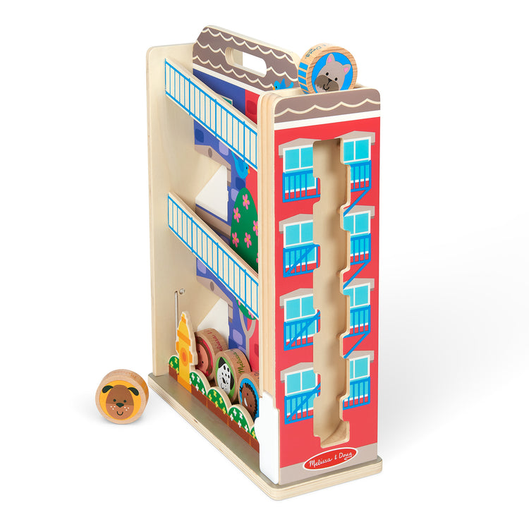 The loose pieces of The Melissa & Doug GO Tots Wooden Town House Tumble with 6 Disks