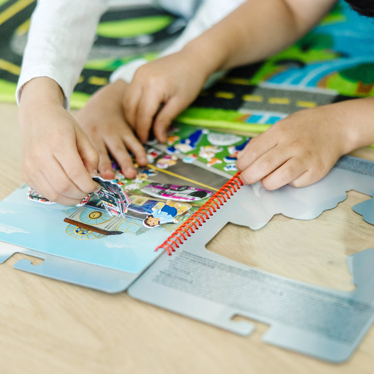 A kid playing with The Melissa & Doug PAW Patrol Restickable Puffy Stickers - Big Truck Pups