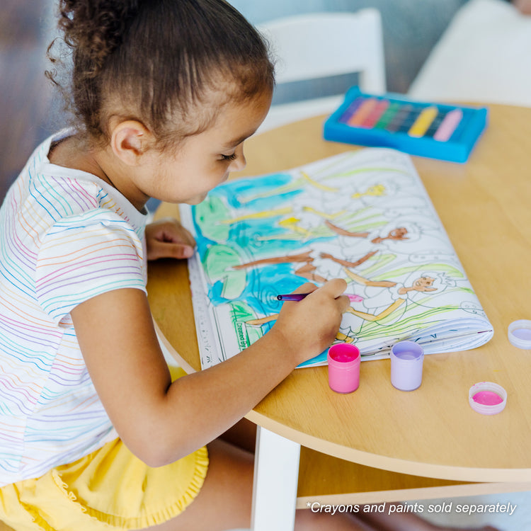 A kid playing with The Melissa & Doug Jumbo 50-Page Kids' Coloring Pad - Horses, Hearts, Flowers, and More