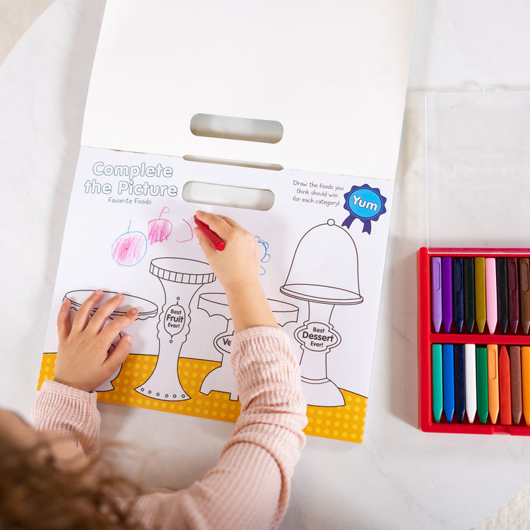 A kid playing with The Melissa & Doug Playmats Food Fun Take-Along Paper Coloring And Learning Activity Pads (24 Pages)