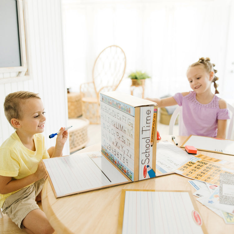 A kid playing with The Melissa & Doug School Time! Classroom Play Set Game - Be Teacher or Student