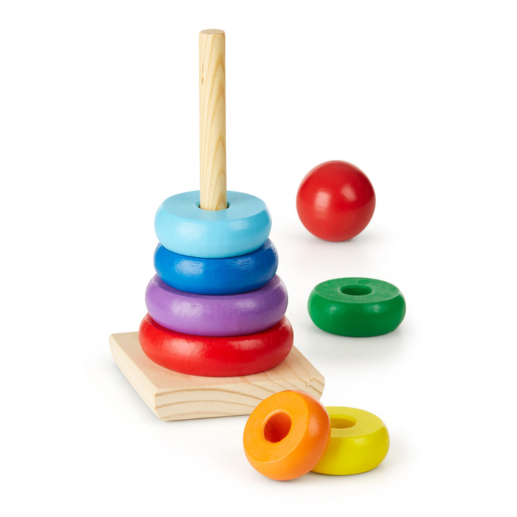 The loose pieces of The Melissa & Doug Rainbow Stacker Wooden Ring Educational Toy