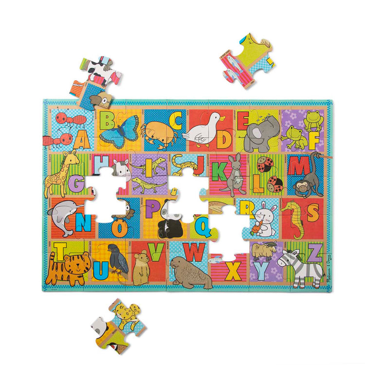 The loose pieces of The Melissa & Doug Natural Play Giant Floor Puzzle: ABC Animals (35 Pieces)