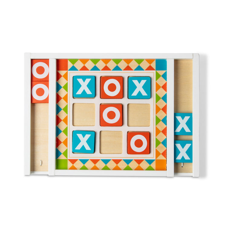 The loose pieces of The Melissa & Doug Wooden Tic-Tac-Toe Board Game with 10 Self-Storing Wooden Game Pieces (12.5” W x 8.5” L x 1.25” D)