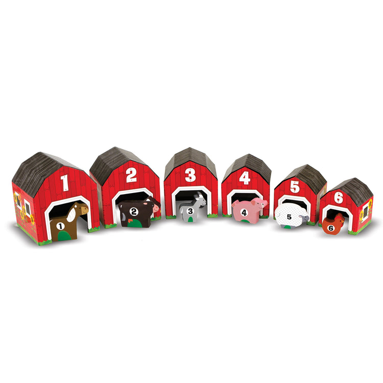 The loose pieces of The Melissa & Doug Nesting and Sorting Barns and Animals With 6 Numbered Barns and Matching Wooden Animals