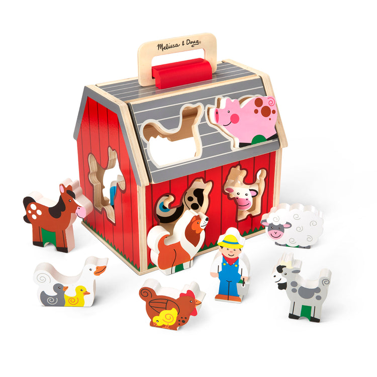 The loose pieces of The Melissa & Doug Wooden Take-Along Sorting Barn Toy with Flip-Up Roof and Handle 10 Wooden Farm Play Pieces