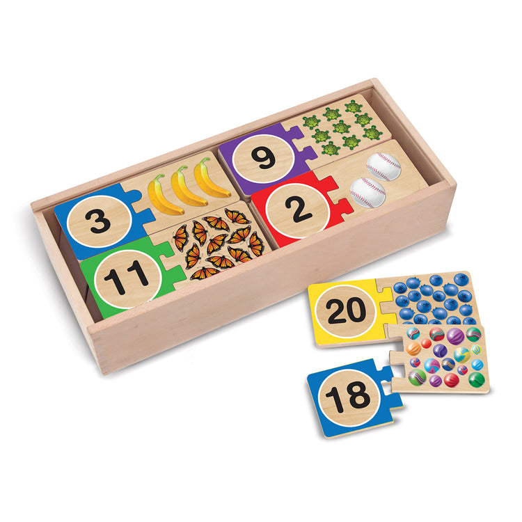 The loose pieces of The Melissa & Doug Self-Correcting Wooden Number Puzzles With Storage Box (40 pcs)