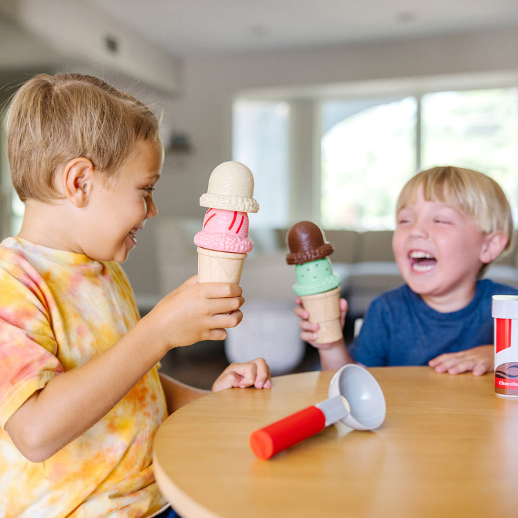 A kid playing with The Melissa & Doug Scoop and Stack Ice Cream Cone Magnetic Pretend Play Set, Multicolor