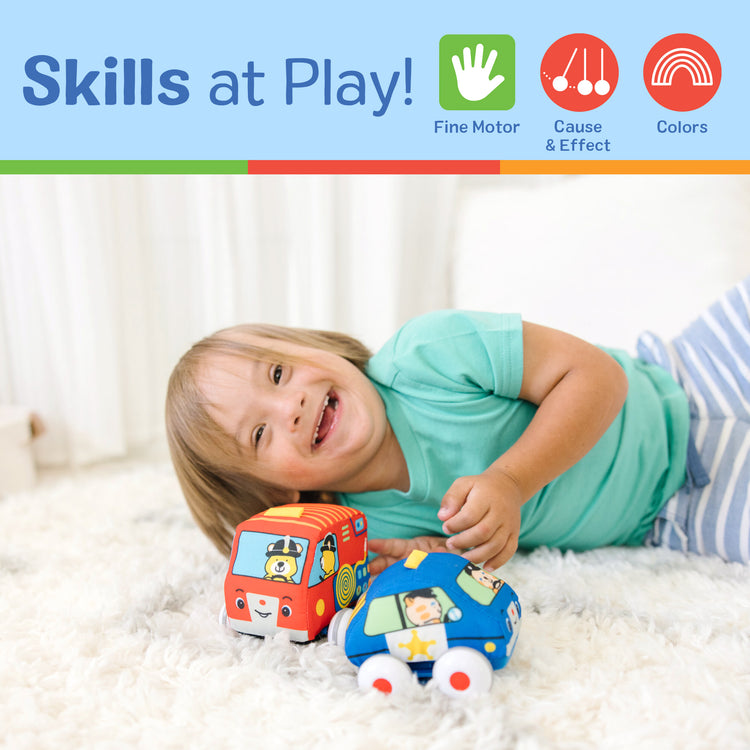 A kid playing with The Melissa & Doug K's Kids Pull-Back Vehicle Set - Soft Baby Toy Set With 4 Cars and Trucks and Carrying Case