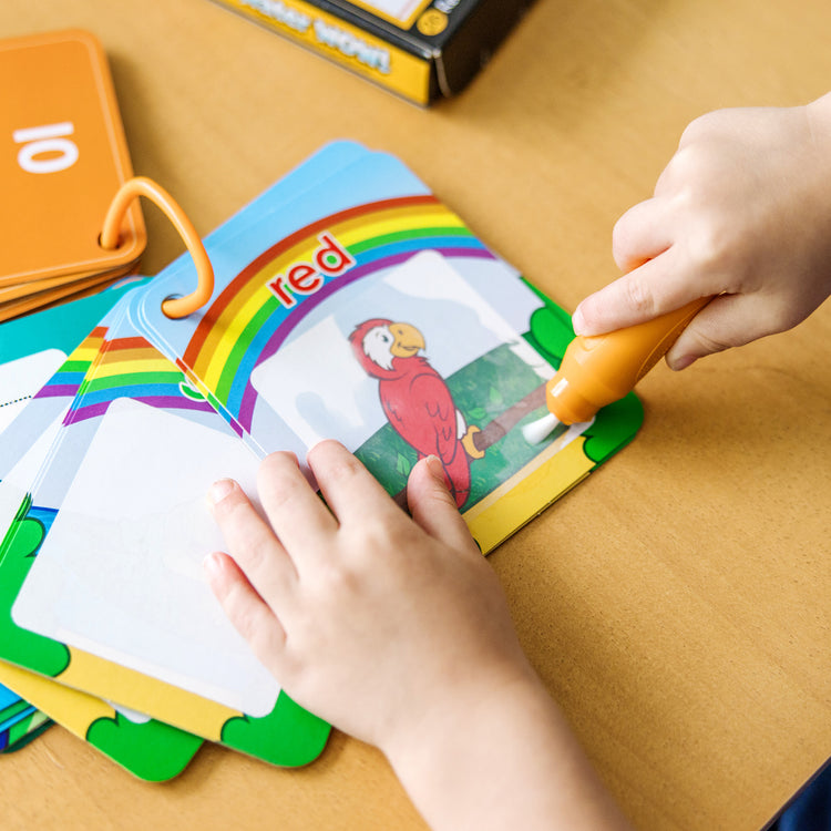 A kid playing with The Doug On the Go Water Wow! Reusable Water-Reveal Cards - Shapes, Numbers, Colors