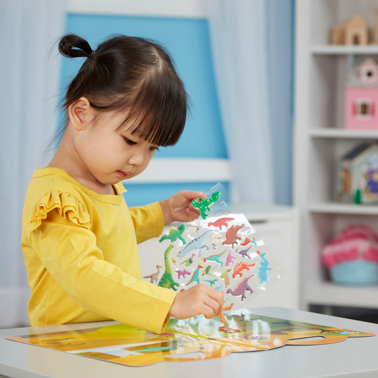 A kid playing with The Melissa & Doug Dinosaur Puffy Sticker Play Set Travel Toy with Double-Sided Background, 36 Reusable Puffy Stickers