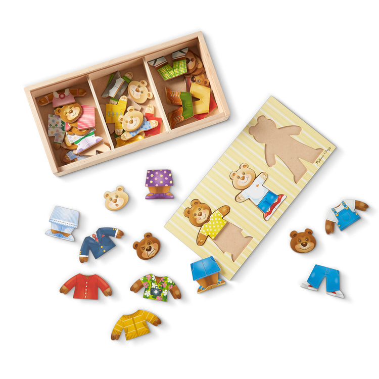 The loose pieces of The Melissa & Doug Mix 'n Match Wooden Bear Family Dress-Up Puzzle With Storage Case (45 pcs)