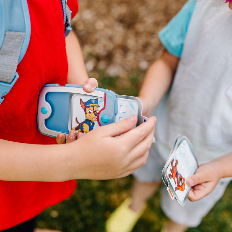 A kid playing with The Melissa & Doug PAW Patrol Pup Pack Backpack Role Play Set (15 Pieces)