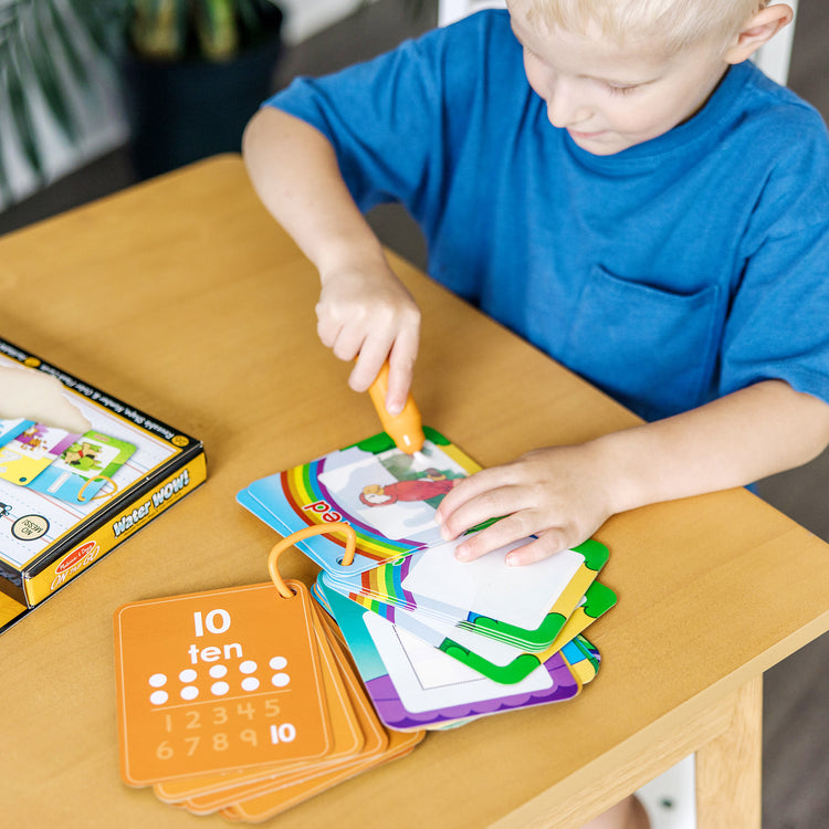 A kid playing with The Doug On the Go Water Wow! Reusable Water-Reveal Cards - Shapes, Numbers, Colors