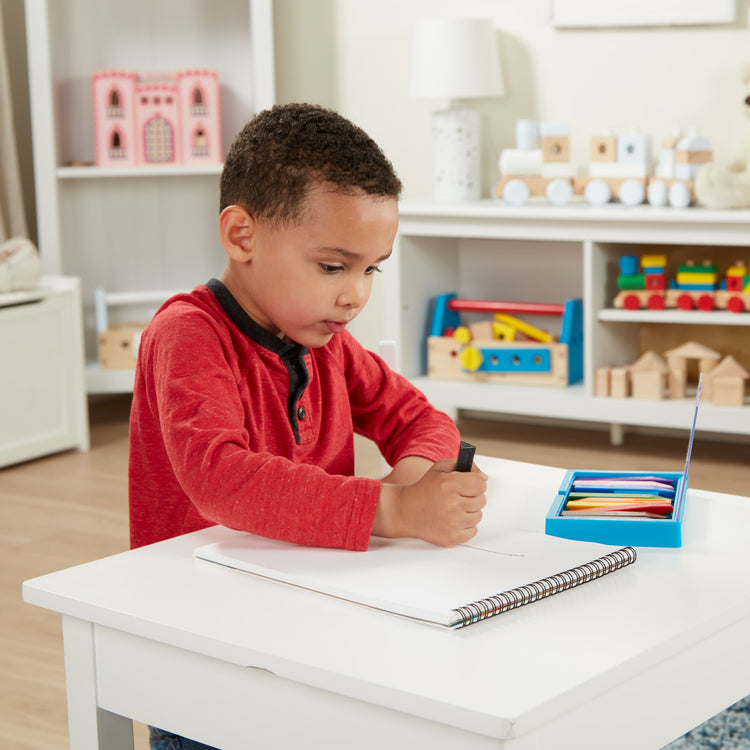 A kid playing with The Sketch Pad (9\\x12\\)