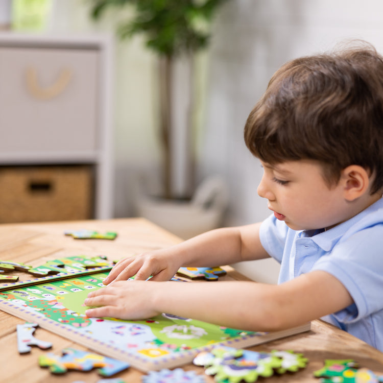 A kid playing with The Melissa & Doug Wooden Animal Chase Jigsaw Spinning Gear Puzzle – 24 Pieces