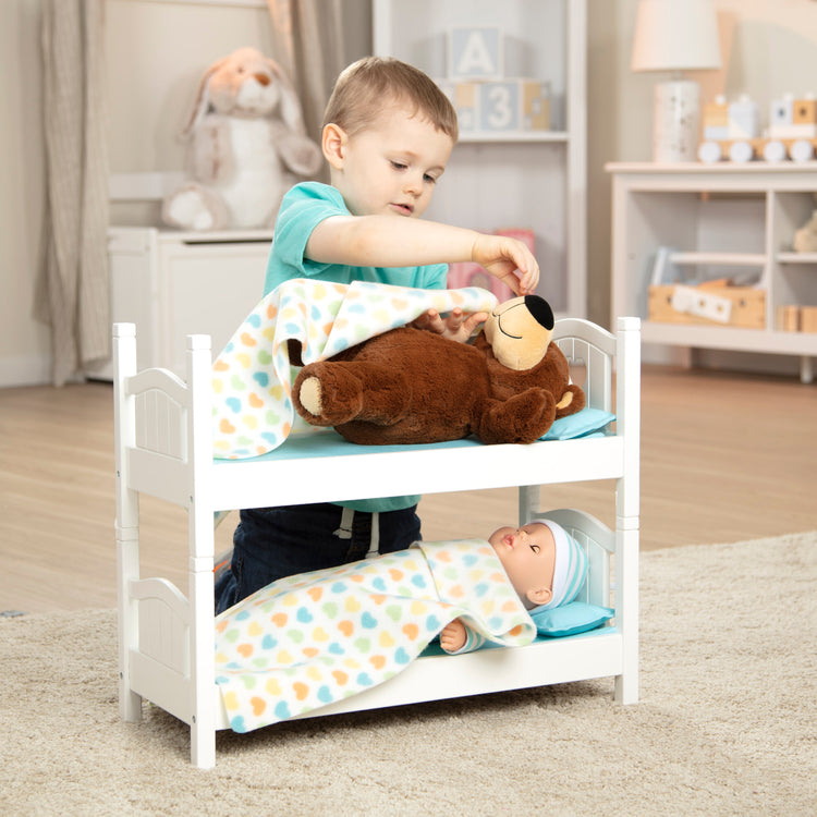 A kid playing with The Melissa & Doug Mine to Love Wooden Play Bunk Bed for Dolls, Stuffed Animals - White (2 Beds, 17.4”H x 9.1”W x 20.7”L Assembled and Stacked)