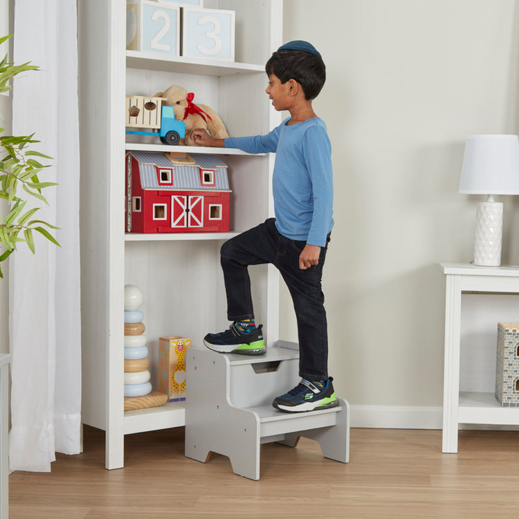 A kid playing with The Melissa & Doug Kids Furniture Wooden Step Stool - Gray