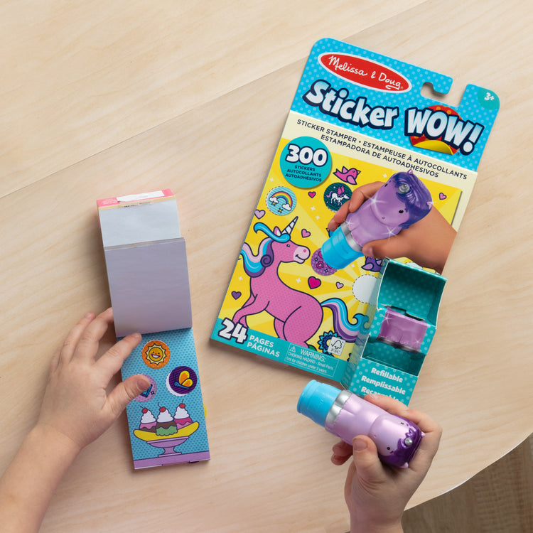 A kid playing with The Melissa & Doug Sticker WOW!™ Purple Unicorn Bundle: 24-Page Activity Pad, Sticker Stamper, 500 Stickers, Arts and Crafts Fidget Toy Collectible Character