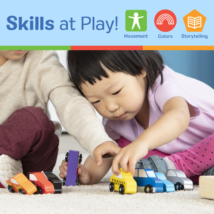 A kid playing with The Melissa & Doug Wooden Cars Vehicle Set in Wooden Tray - 9 Pieces