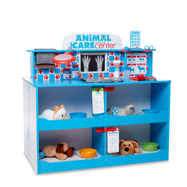 A child on white background with The Melissa & Doug Animal Care Veterinarian and Groomer Wooden Activity Center for Plush Stuffed Pets (Not Included)