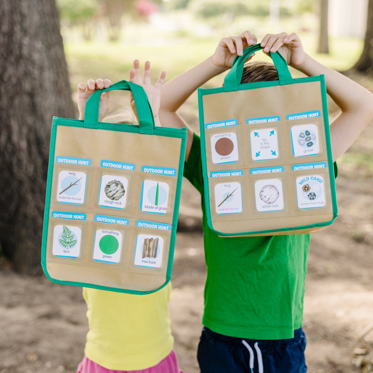 A kid playing with The Melissa & Doug Let’s Explore Indoor/Outdoor Scavenger Hunt Play Set – 80 Double-Sided Cards