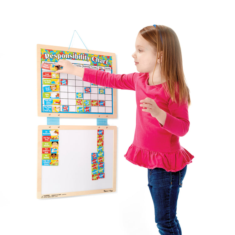 A child on white background with The Melissa & Doug Magnetic Wooden Responsibility Chart