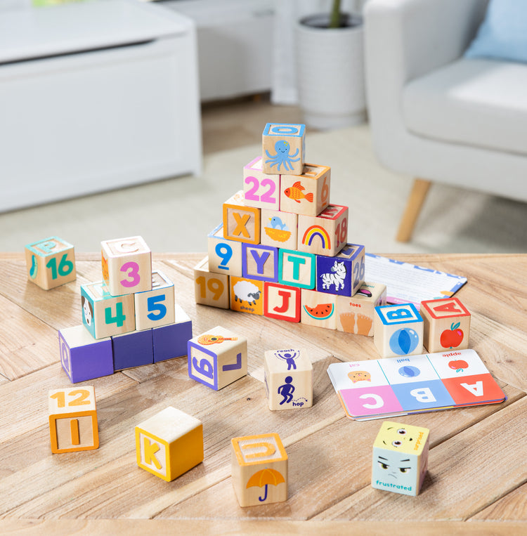 A playroom scene with The Melissa & Doug Ms. Rachel Letter, Number, and Game Wooden Learning Blocks with Activity Cards for Girls and Boys Toddlers Ages 18 Months+