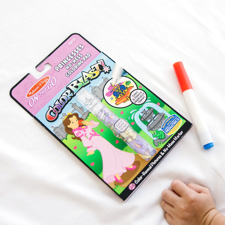 A kid playing with The Melissa & Doug On the Go ColorBlast! Activity Book - Princess (24 Pages)