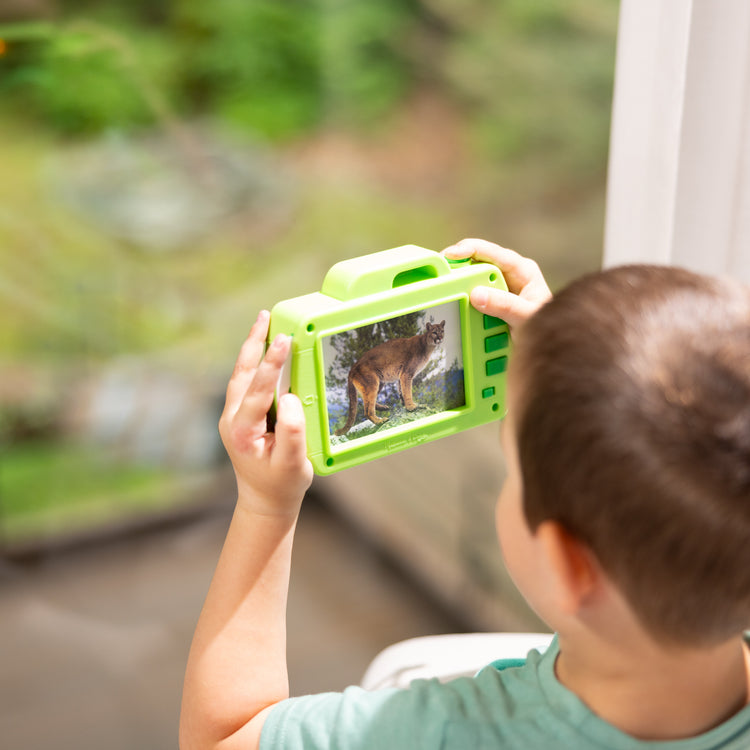 A kid playing with The Melissa & Doug Rocky Mountain National Park Sights and Sounds Wooden Toy Camera Play Set