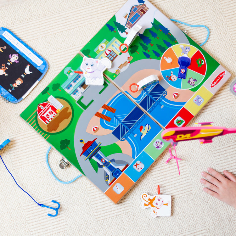 A kid playing with The Melissa & Doug Paw Patrol 2 Spy, Find, & Rescue