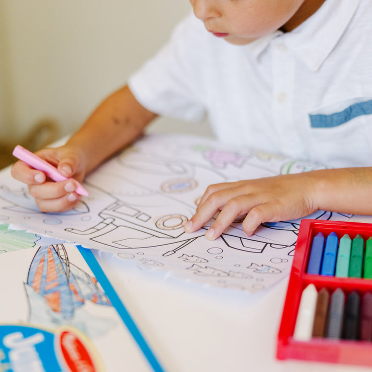 A kid playing with The Melissa & Doug Jumbo Coloring Pad: Vehicles - 50 Pages of White Bond Paper (11 x 14 inches)