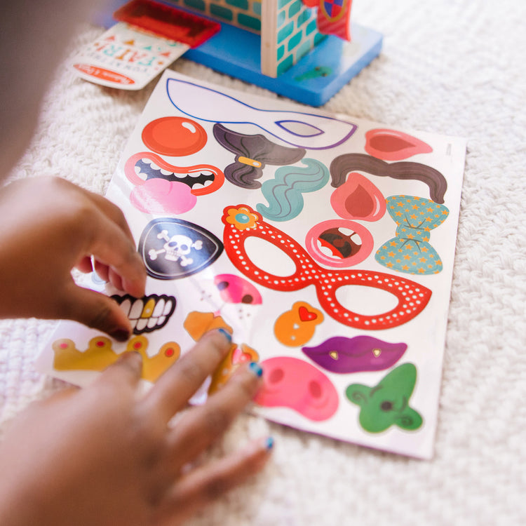 A kid playing with The Melissa & Doug Fun at the Fair! Wooden Double-Sided Funhouse Mirror