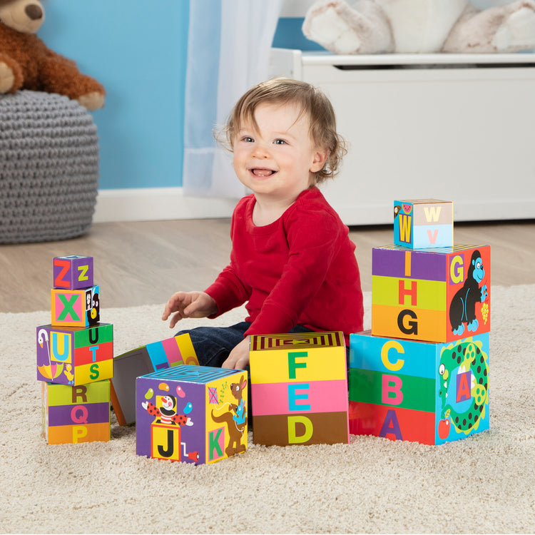 A kid playing with The Melissa & Doug Deluxe 10-Piece Alphabet Nesting and Stacking Blocks