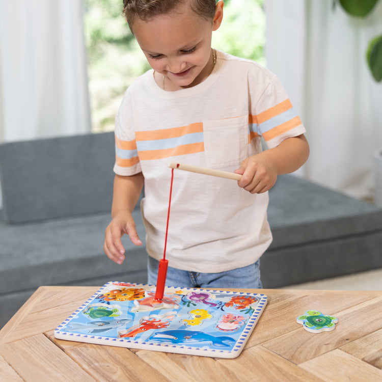 The front of the box for The Melissa & Doug Magnetic Wooden Fishing Game and Puzzle With Wooden Ocean Animal Magnets