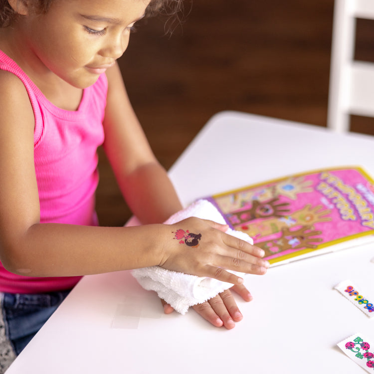 A kid playing with The My First Temporary Tattoos - Pink