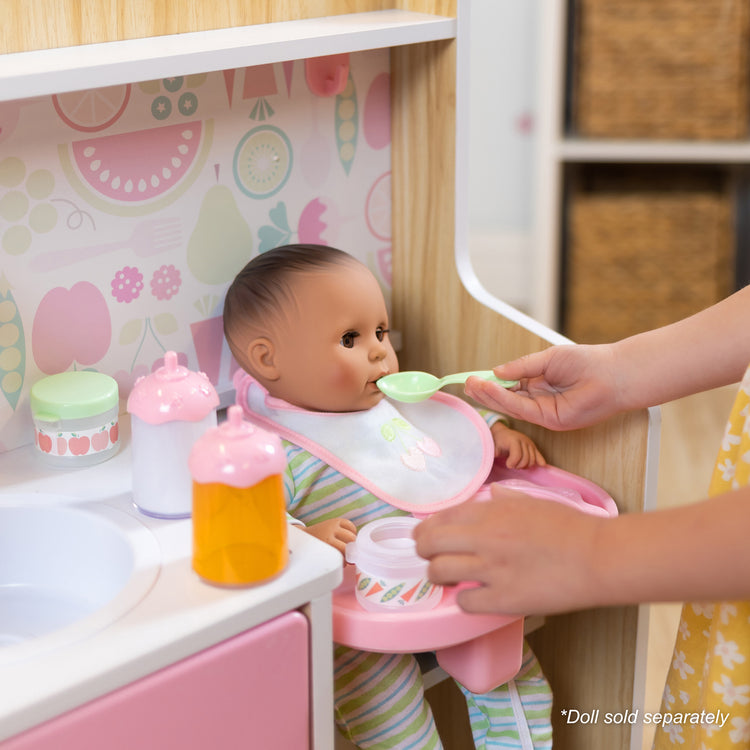 A kid playing with The Melissa & Doug Baby Care Center and Accessory Sets